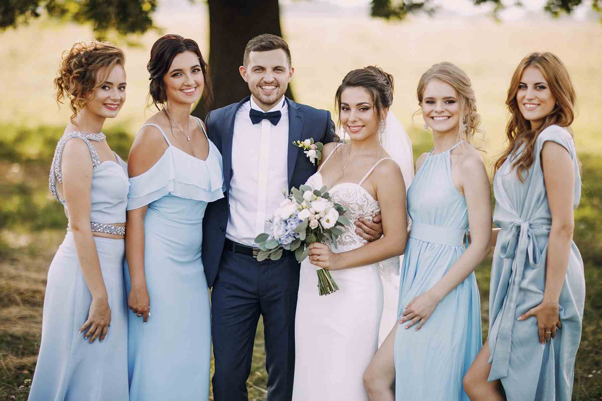 Bride and groom with bridesmaids in formal wear
