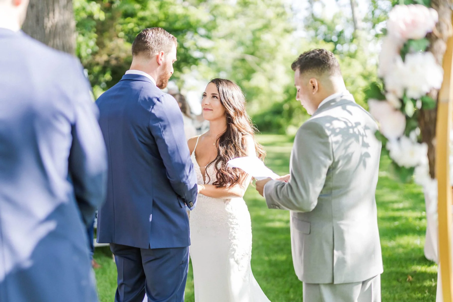 Bride and groom during wedding ceremony. Groom and best man standing.