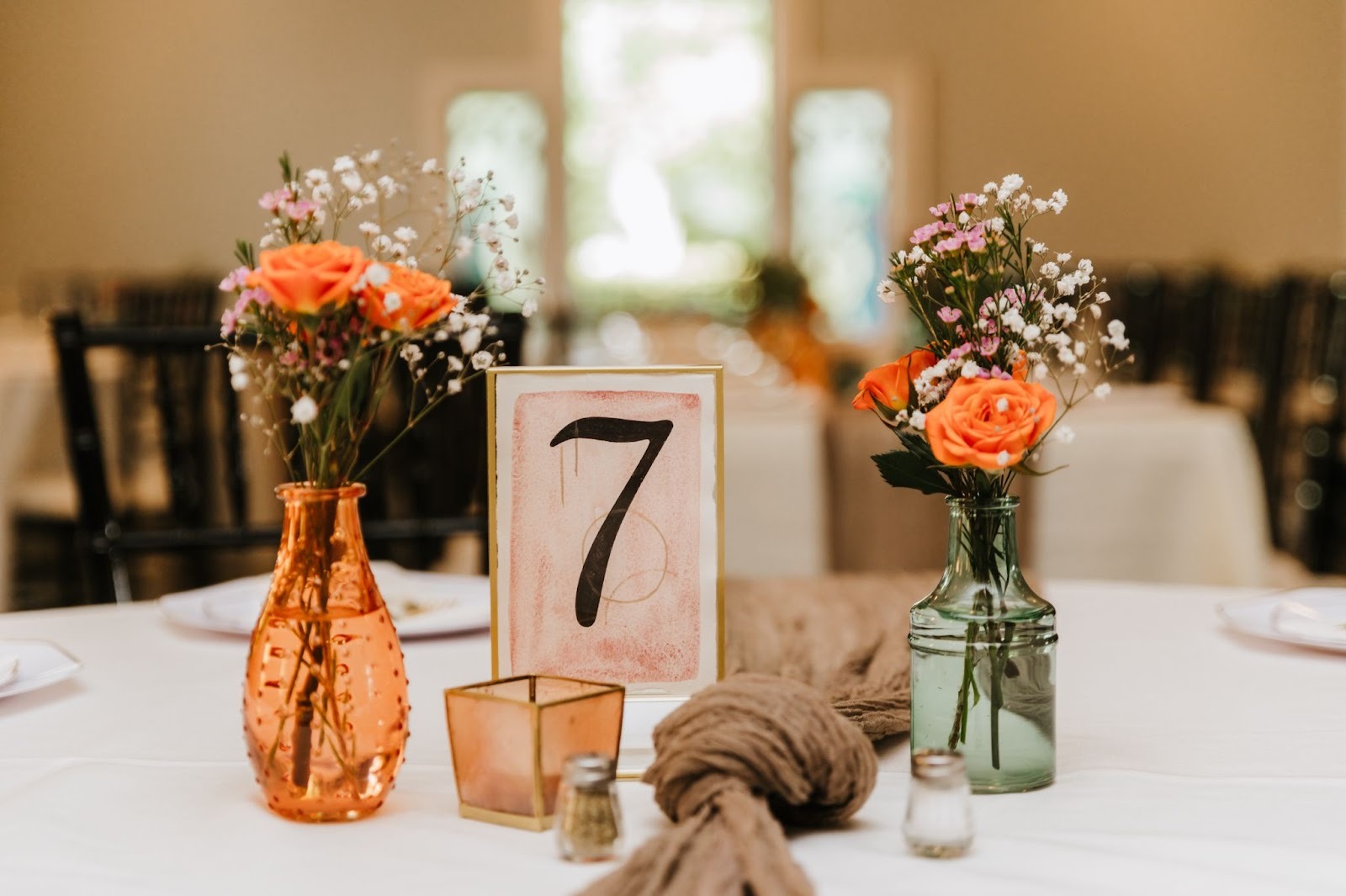 A wedding table setting with flowers and table number 7