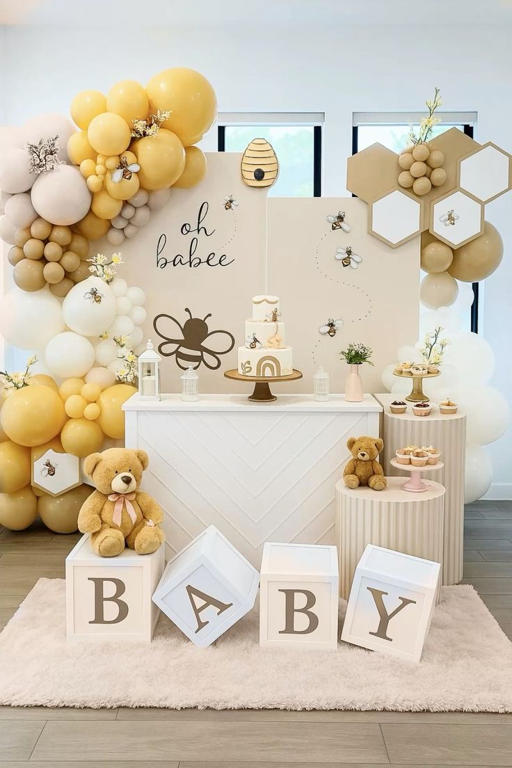 A neutral themed baby shower with honey bee decorations. A cake and teddy bear on display.