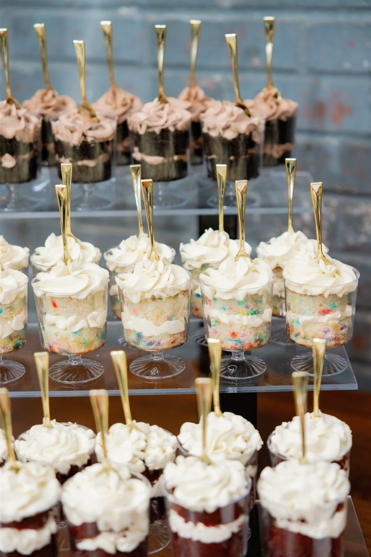 Dessert cups with whipped cream and spoons. Various flavors on display.